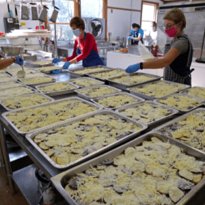 So many trays of Potatoes to bake! These were then divided into appropriate serving sizes to nourish our neighbors.