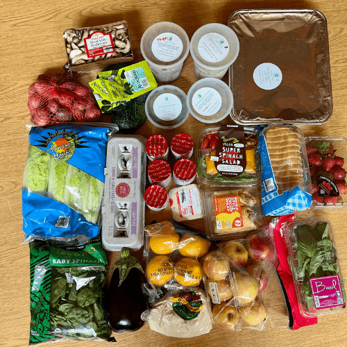 A box for a family of 4 included: Boy Choy Chicken soup, Burgers, Scalloped Potatoes, Roasted Chicken and slaw along with 30 pounds of groceries with fresh fruits and vegetables, bread, dairy, and more!