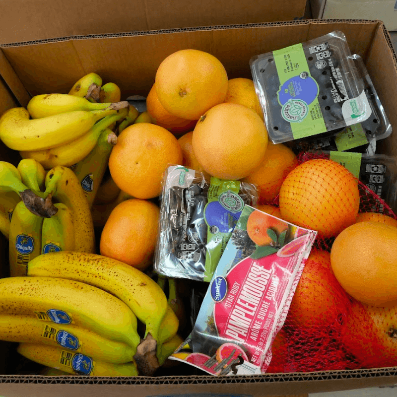 box of bananas, oranges, blueberries, and other rescued fruits