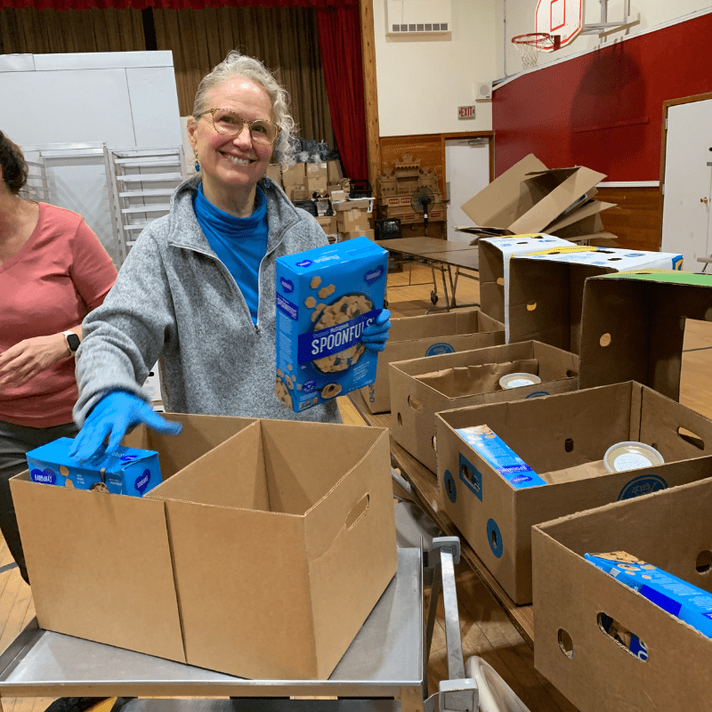 Volunteer packing grocery boxes