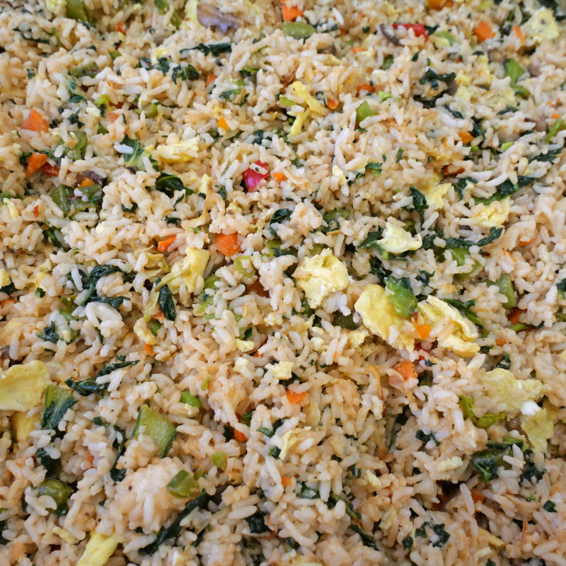 close up of fried rice with peas, carrots, and other vegetables, and eggs