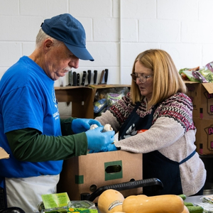 Two volunteers sorting produce