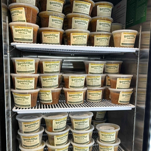 an open freezer filled with pints of prepared meals